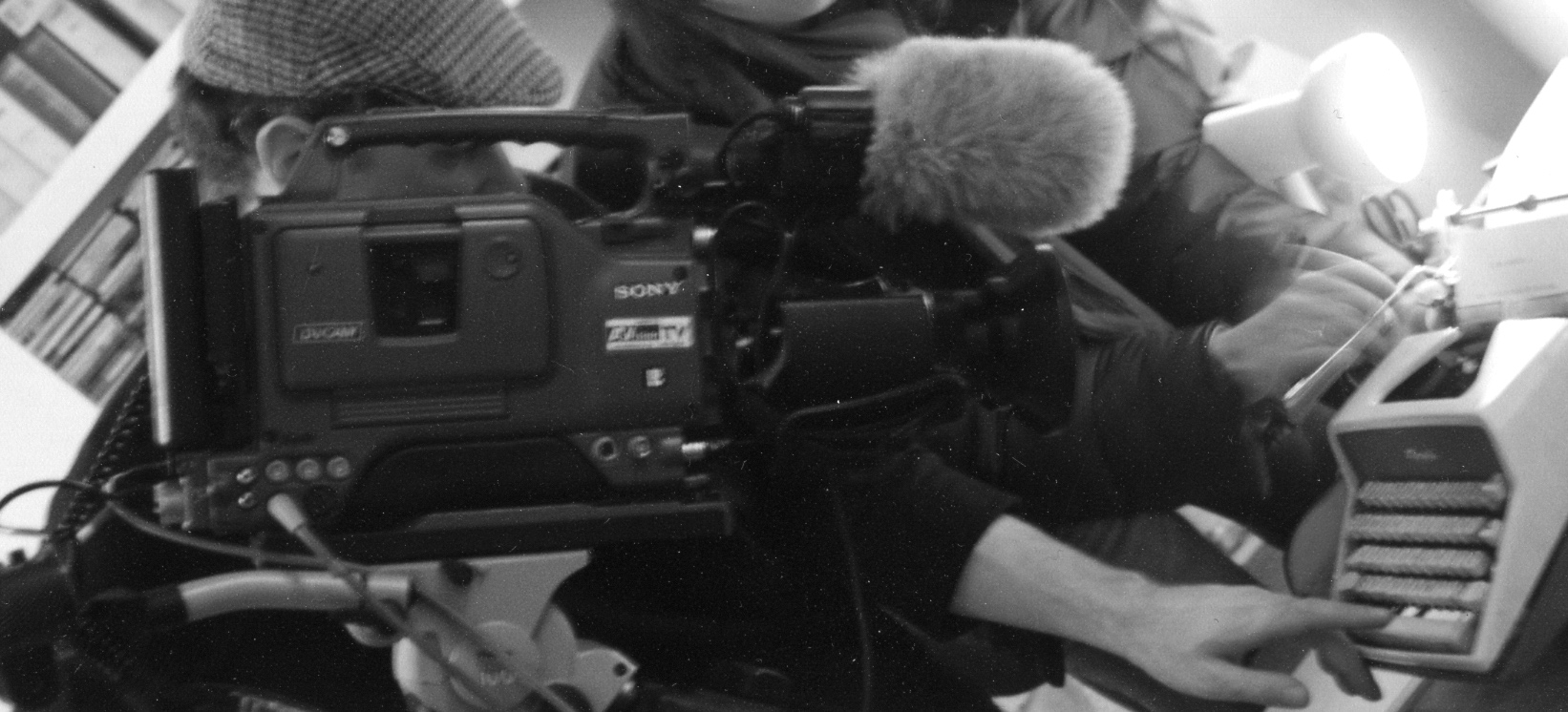 A big old DV camera pointing at an old typewriter