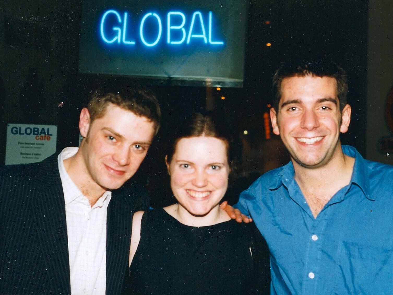 Tom Fogg, Wendy Bevan-Mogg and Nic Wistreich in front of Global Cafe in Golden Square on 2nd February 2000. It is marked with a sign 'global'.