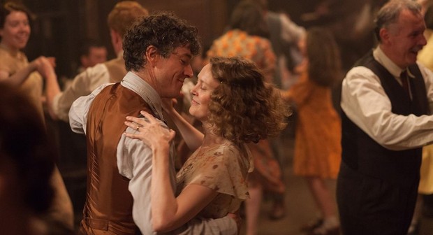 A still from film Jimmy's Hall - Barry Ward and Simone Kirby embrace dancing as the world around them dances out of focus.