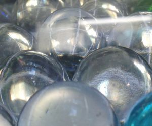 Marbles - with a red, blue and green one, at a distance.