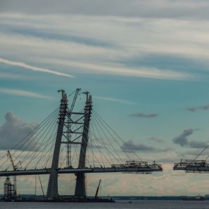 Photo of a bridge being built against a beautiful sky by Tatiana P on Unsplash